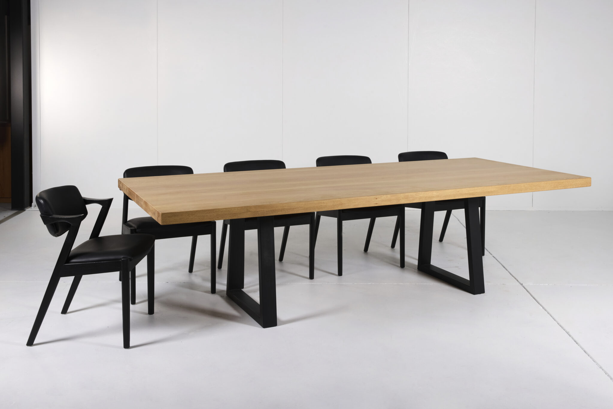 Image of Noosa Dining Table by Arranmore Furniture, showcasing its sleek U or Klein Leg design in a modern dining setting.